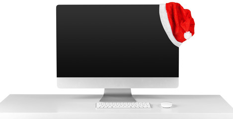 Monitor and Santa Claus red christmas hat isolated on white background