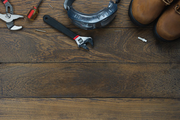 Table top view aerial image of decoration the sign of USA labor day on Sep 3,2018 background concept. Flat lay accessories tools worker and clothing on modern rustic brown wooden with copy space.