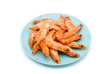 Grilled shrimps on blue plate isolated on white background

