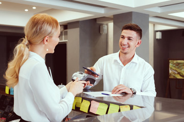 man at hotel reception.