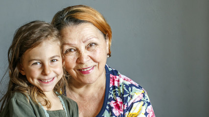 Grandma kisses her beloved granddaughter on the cheek