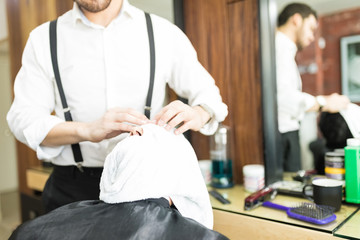 Barber Massaging Client's Face After Applying Hot Towel