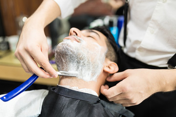 Barber Hands Shaving Man's Stubble With Straight Razors
