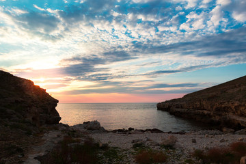 Fototapeta na wymiar Brilliant vacation destination beach sunrise and sea cliffs background