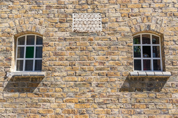 Brick wall with two windows