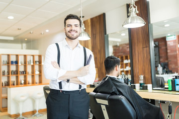 Cool Hairdresser With Arms Crossed By Client On Chair