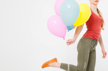 young woman girl running with colored balloons isolated on white background. Copy space