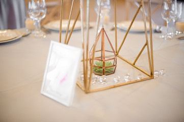 Wedding decor standing on the table on the blurred background