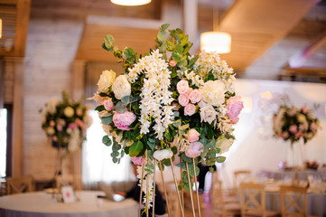 Wedding decor bouquet of pink peonies and roses on the hall