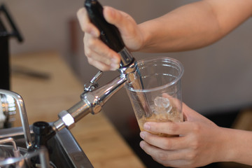 Barista Eject Nitro Cold Brew Coffee to plastic cup