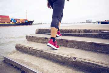 close up feet of woman running exercise up a staircase