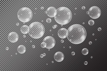 Realistic soap bubbles with rainbow reflection set isolated on the black transparent background