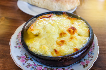 Fried suluguni cheese. Georgian national dish in a clay plate.