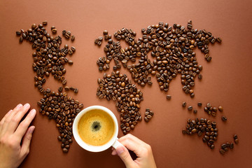 Map of the world made of roasted arabica coffee beans on brown paper background. International...