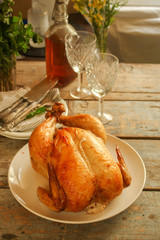 baked bird - a festive dish (laying on a wooden table). food background