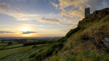 Fototapeta na wymiar Summer sunset over Brentor, with the church of St Michael de Rupe - St Michael of the Rock, on the edge of the Dartmoor National Park, Devon, UK