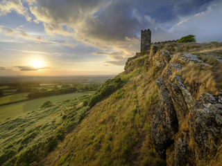 Summer sunset over Brentor, with the church of St Michael de Rupe - St Michael of the Rock, on the edge of the Dartmoor National Park, Devon, UK