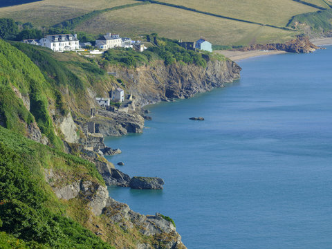 Sunrise over Start Bay from near the light house looking along the coast towards Beesands and Slapton Sands with the remains of the 'lost village' of Hallsands visible, Devon, UK