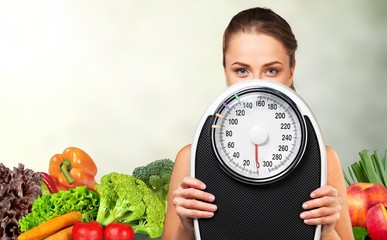 Beautiful young s woman holding scales