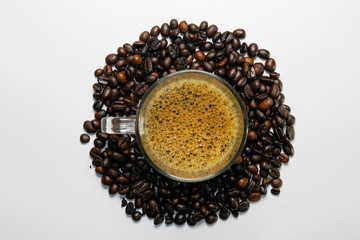 Close up of Heart shape roasted roasted coffee beans with coffee beans background isolated on white.