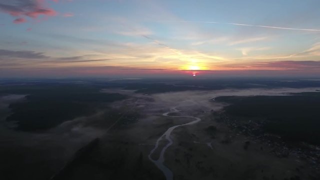 Aerial View. Panoramic summer morning landscape. The picturesque landscape with river, dam on the river, trees and field with Incredible sun. Morning Fog.