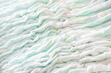 A large stack of baby diapers, close-ups, diaper packaging