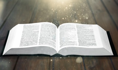 Open book on old wooden table