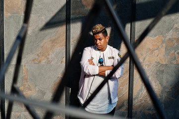 Stylish hipster arab man guy posed outdoor in street. Style rap singer.