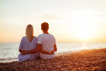 Young happy couple on seashore.