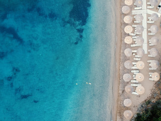 Beach with umbrellas and a bright water