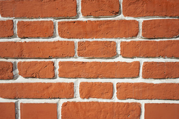 Background brick brown wall with white seams.