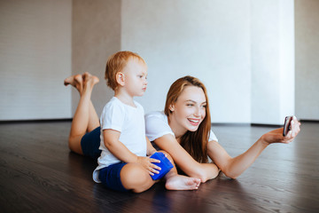 Happy mother with son and smartphone