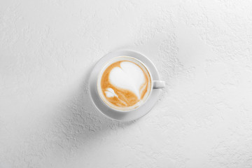 Cup of cappuccino coffee on white background