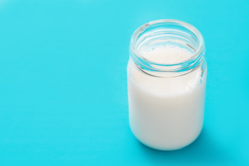 Milk glass on blue background. Copyspace.

