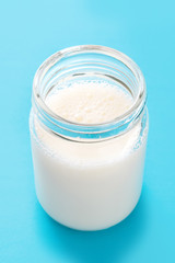 Milk glass on blue background.

