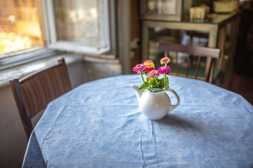 Pink wildflowers in glass on the table
