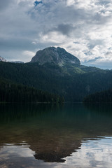 Fototapeta premium Aerial view at a beautiful lake in the mountains. Black Lake, Montenegro.
