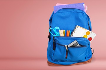Open blue school backpack on desk