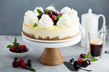 Classic New York cheesecake decorated with whipped cream