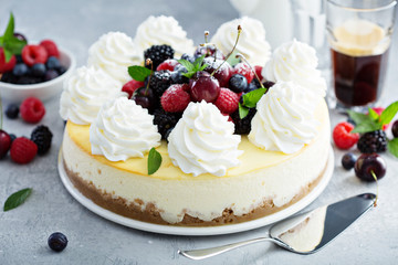 Classic New York cheesecake decorated with whipped cream