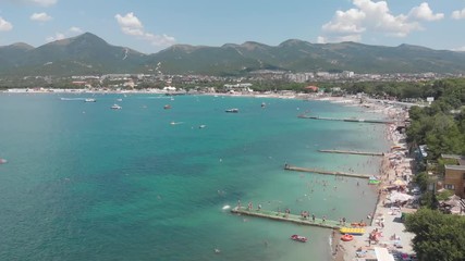 Aerial photography of the sea with boats and mountains