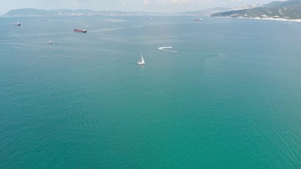 Aerial photography of the sea with boats and mountains