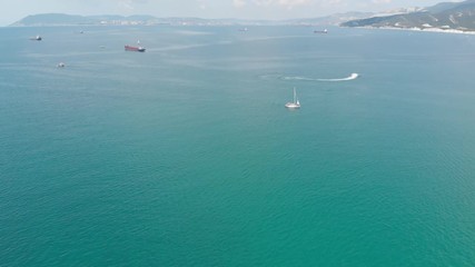 Aerial photography of the sea with boats and mountains