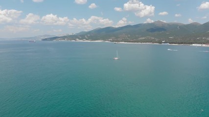 Aerial photography of the sea with boats and mountains