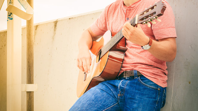 Trendy guy with guitar outdoor
