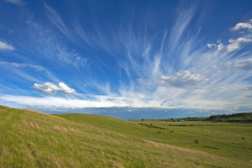 beautiful summer landscape with green hills and blue sky and clouds