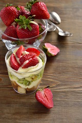 Layered dessert with strawberries, kiwi, biscuit and cream, Trifle, vertical, copy space