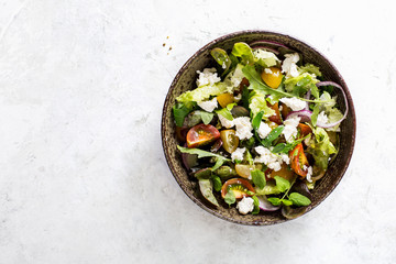 Vegetable salad with soft cheese and sesame.