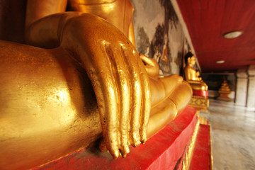closeup hand of gold Buddha statue