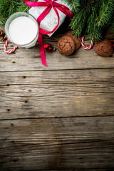 Christmas background with decorations, chocolate cookies and gift boxes on wooden background top view copy space